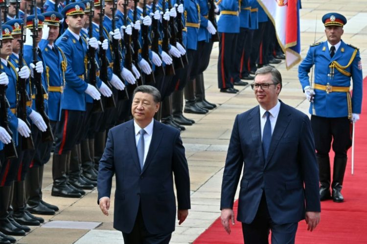 Xi and his wife Peng Liyuan were greeted by Vucic on a red carpet outside the main government offices  . ©AFP